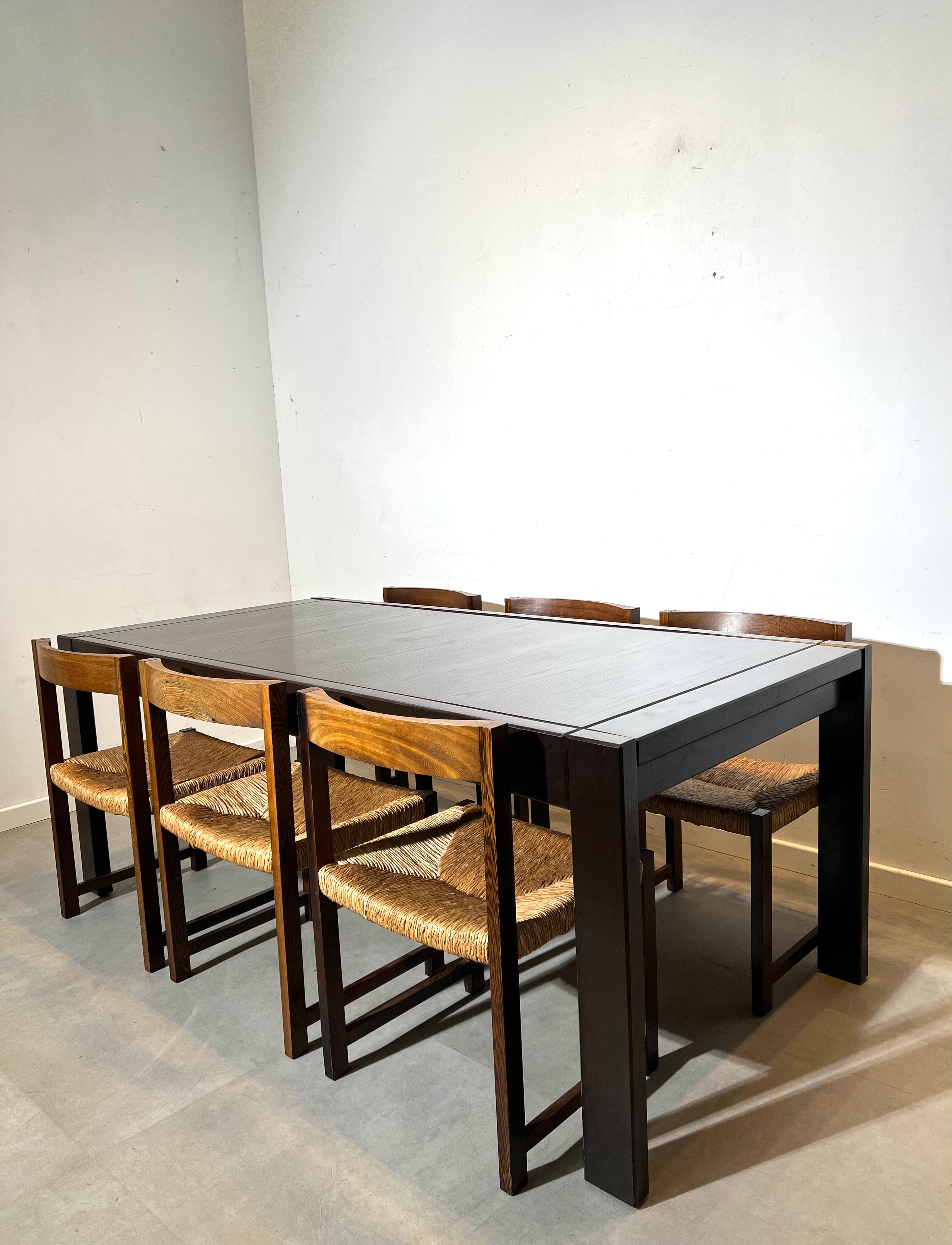 Extendable dark oak dining table with 6 rush chairs