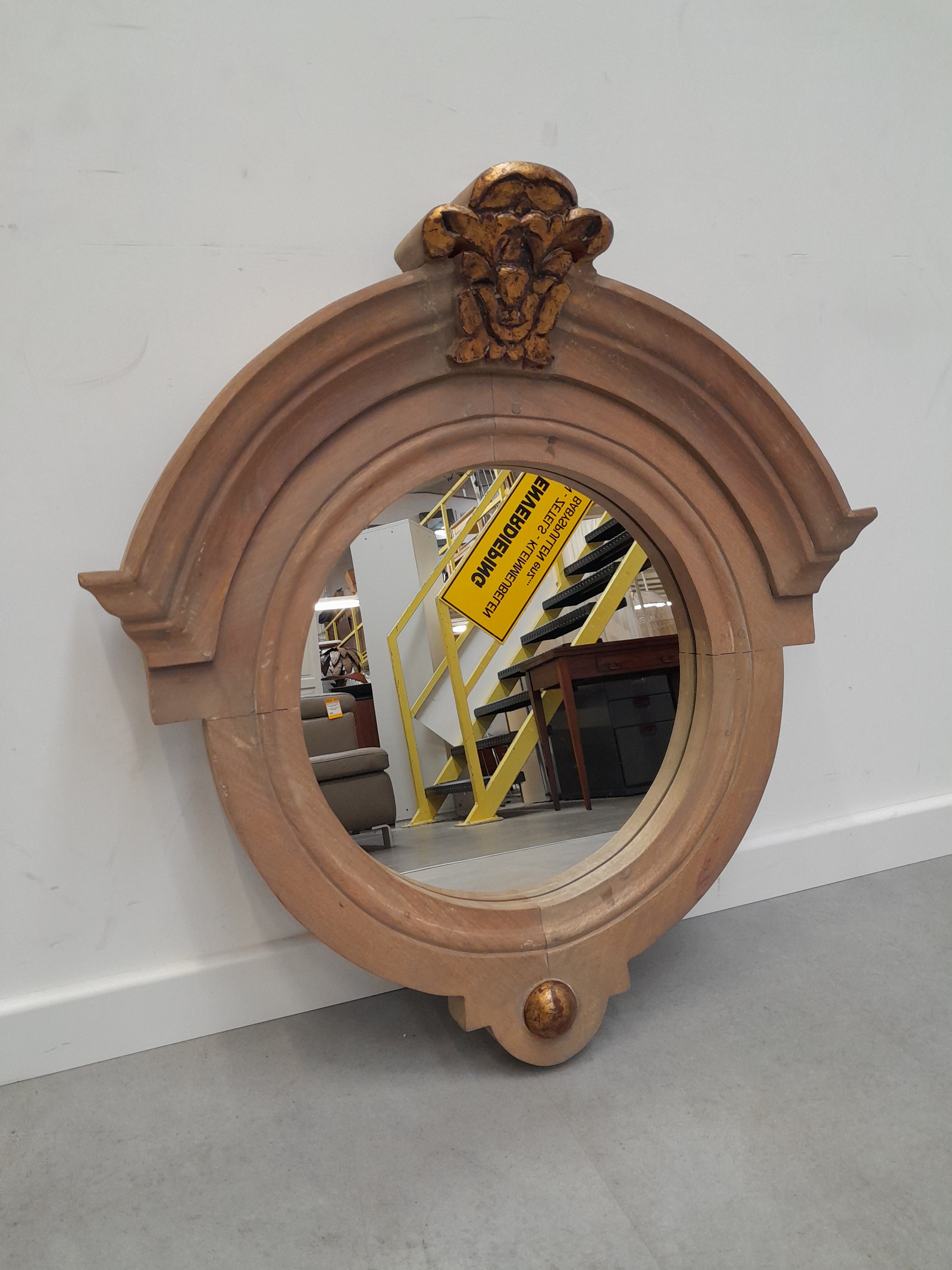 Round mirror in wooden frame