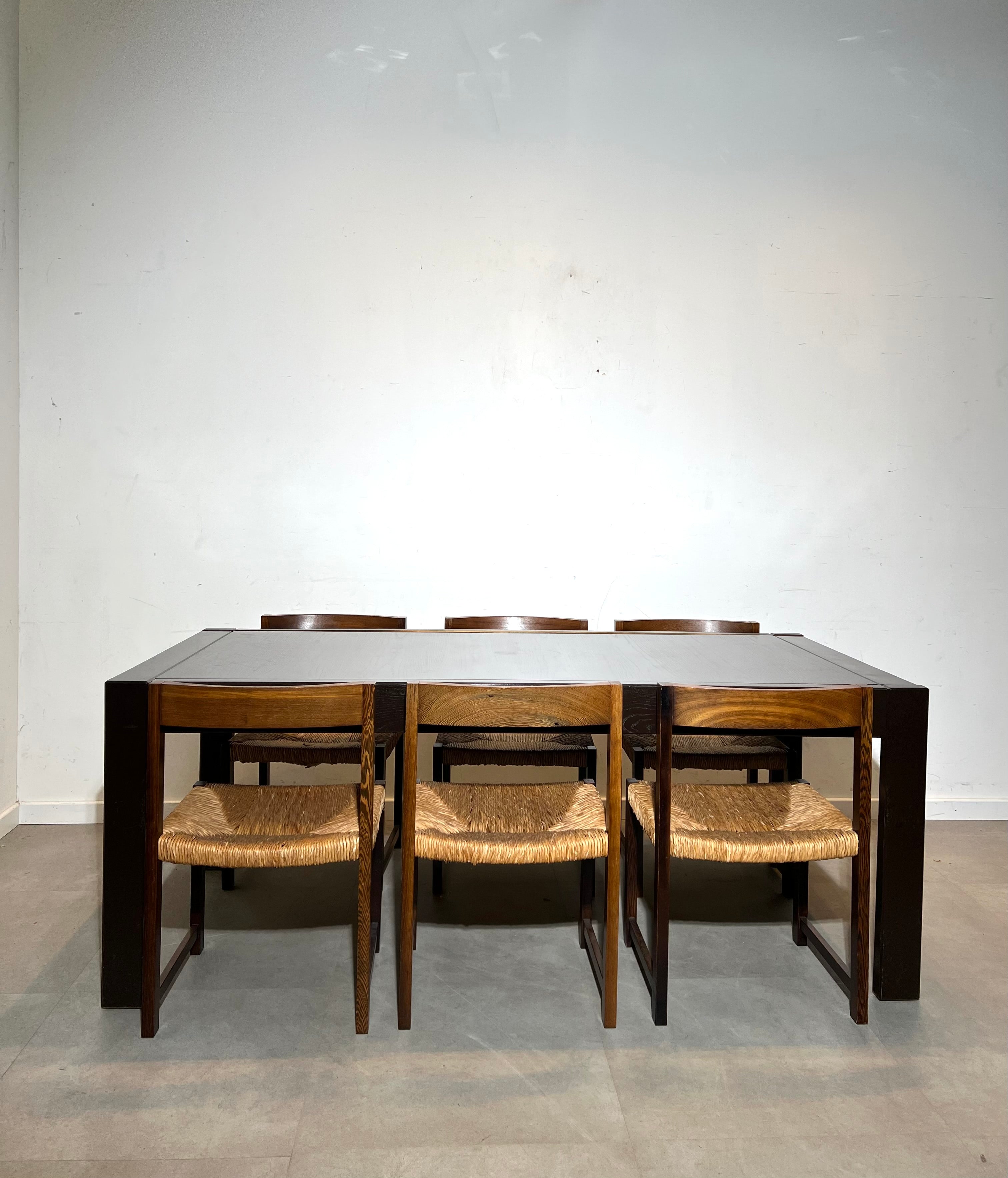Extendable dark oak dining table with 6 rush chairs
